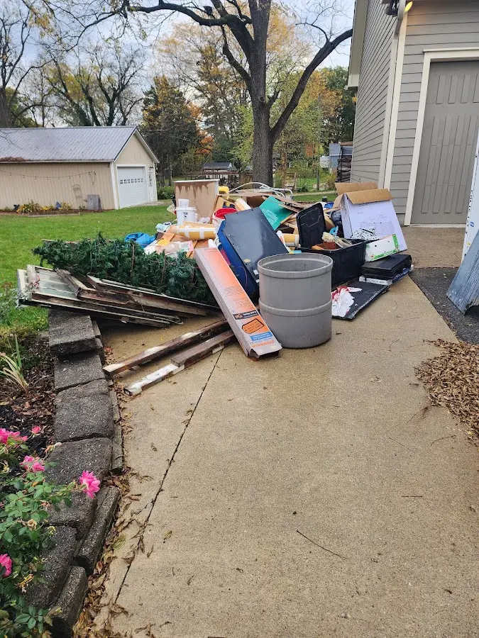 Dumpster being loaded with debris for Demolition Dumpster Rental in Bunnell